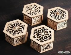 four carved wooden hexagonals sitting on top of a wood table with an intricate design