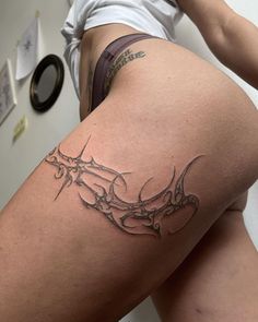 a woman with a tattoo on her thigh