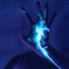 a person's hand with blue light painted on it in the middle of their body