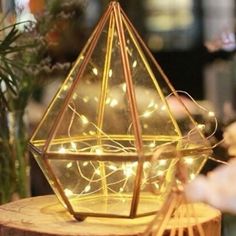 a wooden stand with a lighted glass pyramid on it