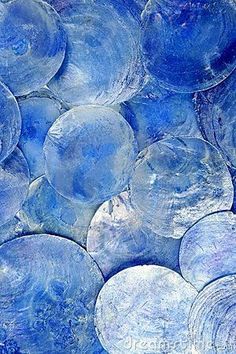 many blue glass discs are stacked on top of each other