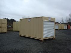 several shipping containers are lined up in a parking lot