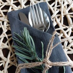 a fork, knife and napkin wrapped in twine