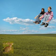 two people are flying through the air with a rabbit in front of them and an image of a deer behind them