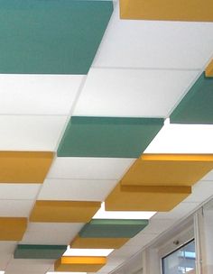 the ceiling in an office building is painted green, yellow and white