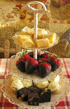 three tiered trays holding pastries and strawberries