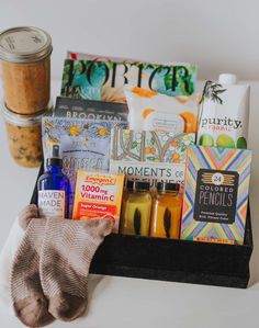 an assortment of food and drinks on a tray next to a pair of mitts