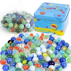 an assortment of marbles in a plastic bag next to a blue tin box filled with them