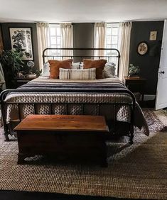 a bedroom with a large bed and wooden bench in it's centerpieces