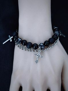 Elevate your gothic style with our handmade cross charm Gothic black beaded bracelet with chains. This edgy bracelet features intricate black beads and a striking cross charm, exuding a dark, mysterious allure. The addition of chains adds an extra touch of punk-inspired flair. Handcrafted with care, this bracelet is a unique statement piece that will add an element of intrigue to any outfit.   Please note that this product includes only the bracelet. Gothic Beaded Bracelet, Black Punk Chain Bracelet As A Gift, Black Punk Style Chain Bracelet As Gift, Black Punk Style Chain Bracelet For Gift, Punk Style Black Chain Bracelet Gift, Alternative Style Black Bracelets As Gift, Alternative Style Black Bracelet For Gift, Alternative Style Black Bracelet Gift, Alternative Black Chain Jewelry