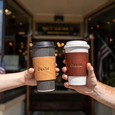 two people holding up coffee cups with the words david and mason written on each cup