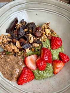 a white plate topped with fruit and granola