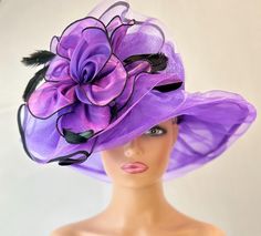 The featured hat is a purple organza hat. This one of a kind hat made by Letty is adorned with an exotic crinoline and chiffon design . Several feathers emerge from the design. This hat is a dramatic, classic and unique one of a kind hat that is a must have for any woman who loves hats. Creating the look that suits you best comes from turning the hat on your head creating a different look with each twist till you find the look you love...  This classic one of a kind hat made by Letty is a beautiful church hat or a Kentucky Derby Hat.  Also perfect  for  an Easter Hat, Tea Party hat,Wedding Party Hat, Fancy Dress hat, Downton Abby Hat and other special occasions. Brim:   4" Rise:   3.75 Size:    22" Purple Hats For Royal Ascot Races, Purple Hat For Kentucky Derby Evening, Purple Mini Hat For Church In Spring, Purple Wide Brim Spring Costume Hat, Purple Curved Brim Mini Hat For Kentucky Derby, Purple Mini Hat With Curved Brim For Kentucky Derby, Purple Curved Brim Costume Hat For Party, Purple Top Hat For Spring Wedding, Purple Top Hat For Kentucky Derby