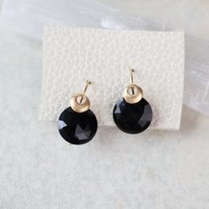 These earrings feature round black spinel gemstones set on gold hooks, with a single bubble accent adding a touch of modern elegance. Round Black Spinel 18k gold Vermeil 3/4' Handmade by Austin Titus Studio in Richmond, VA Elegant Everyday Round Crystal Earrings, Elegant Black Everyday Earrings, Black 14k Gold Earrings For Evening, Black Drop Earrings With French Hook, Elegant Black French Hook Earrings, Elegant Everyday Jewelry With Black Spinel, Minimalist Black 14k Gold Earrings, Black Faceted Earrings As A Gift, Gold Jewelry With Round Black Spinel