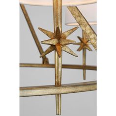 a metal and wood chandelier with three stars on it