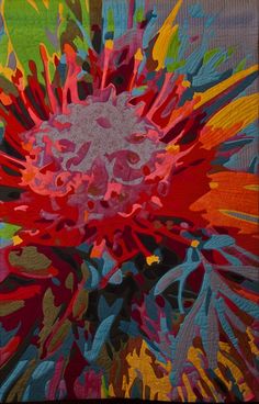 a large colorful flower is on display in this image, it appears to be made out of fabric