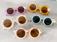 Adorable customized sunglasses for your little ones! These sunglasses are perfect for boys or girls. One size only - and should fit your little ones ages (2-7). Available with or without name personalization. If you would like to customize with a name, please add a note during checkout. Due to the sizing of the sunglasses, we can only fit a maximum of 12 letters for the name. Feel free to mix and match the colors and charms. We have 2 sunglasses styles available (round frames and floral frames). Sunglasses For Girls, Sunglasses For Kids, Beaded Sunglasses, Rainbow Sunglasses, Personalized Sunglasses, Birthday Goodie Bags, Unicorn Princess, Party Favors For Kids Birthday, Baby Presents