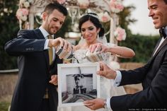 a bride and groom are pouring champagne at their wedding