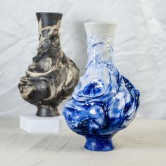 two vases sitting next to each other on a table