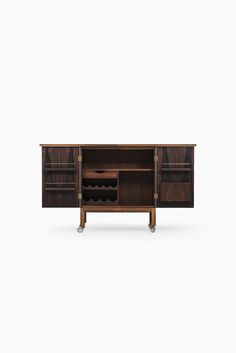 the sideboard is made out of wood and has two wine racks on one end