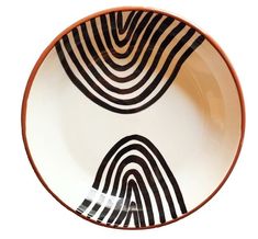 a black and white striped bowl with an orange rim