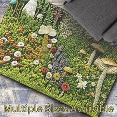 a close up of a rug with flowers and mushrooms on it