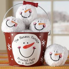 a bucket filled with snowmen sitting on top of a table