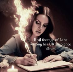 a woman sitting at a table writing in a book with flames coming out of her head