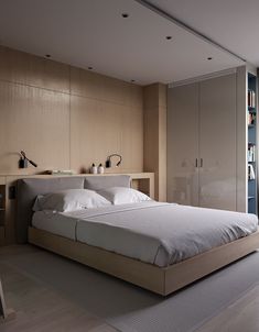 a large bed sitting in the middle of a bedroom next to a book shelf filled with books