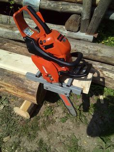 a chainsaw sitting on top of a piece of wood