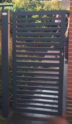 an iron gate with vertical slats on the sides