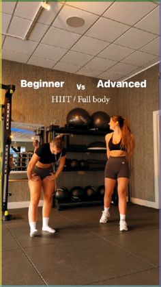 two women standing in front of a gym equipment