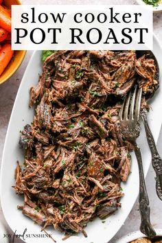 slow cooker pot roast on a white plate with carrots and parsley in the background