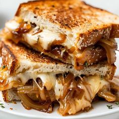 a grilled cheese and onion sandwich on a white plate