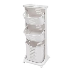 three white baskets are stacked on top of each other in the same basket holder for storage