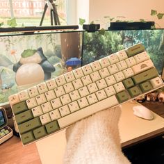 a computer keyboard sitting on top of a desk next to a mouse and cell phone