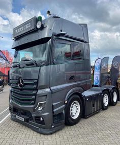 a mercedes semi truck parked in a parking lot