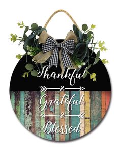 a sign that says grateful and is hanging on the side of a wooden wall with an arrow