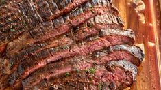 steak sliced up on a wooden cutting board