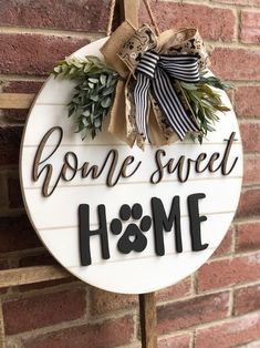 a sign that says bone sweet home with a dog's paw hanging on it