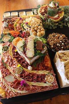 a table filled with lots of different types of food and snacks on top of it