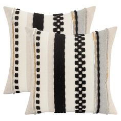 two black and white striped pillows sitting next to each other