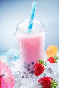 strawberry milkshake with strawberries and umbrellas on ice