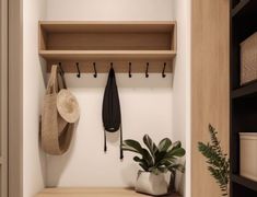 a coat rack with hats, umbrellas and plants