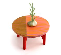 a small table with a plant on top and an odd shaped object sitting on it