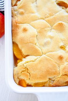 an apple cobbler in a white casserole dish