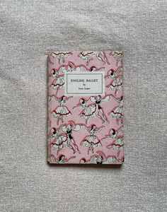 a pink book sitting on top of a bed