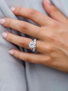 a woman's hand with a diamond ring on it