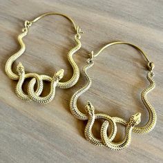 Unleash your wild side with our Snake Hoop Earrings - a captivating fusion of edgy style and timeless elegance. Crafted with precision, these earrings feature a unique snake design that adds a bold touch to your look. Material: High quality brass. Width - Approx 1.5 inches (3.81 cm) Length - Approx 2 inches (5.08 cm) - Striking cobra snake hoop design for a fierce and trendy statement - Made with high quality sturdy solid brass, high durability.  - Versatile style to complement both casual and b Modern Metal Jewelry With Snake Shape, Modern Metal Jewelry In Snake Shape, Edgy Adjustable Gold Jewelry, Adjustable Snake-shaped Metal Jewelry, Unique Metal Jewelry With Snake Shape, Adjustable Snake Shaped Metal Jewelry, Nickel Free Brass Hoop Earrings For Party, Unique Snake-shaped Metal Jewelry, Nickel-free Brass Hoop Earrings For Party