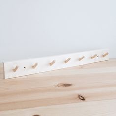 there is a coat rack made out of wood